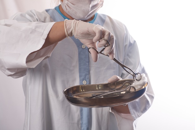 "Surgical tech holding a tray"
